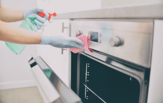 keen clean professional cleaner cleaning an oven